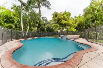 a swimming pool in a yard with a fence at Spacious 5BR Home with Pool, Near Downtown & Beach in Hollywood