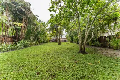 a grassy yard with trees in the distance at Spacious 5BR Home with Pool, Near Downtown & Beach in Hollywood