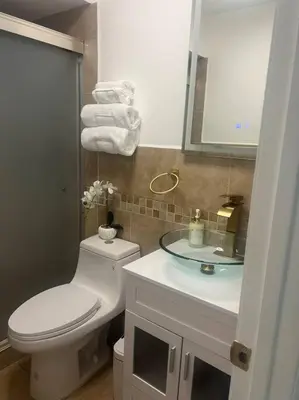 a bathroom with a white toilet and a sink at Hollywood Golden House Modern & luxurious Studio in Hollywood
