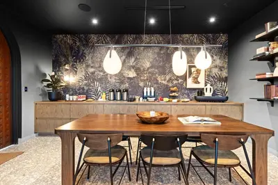 a dining room with a wooden table and chairs at The Rover Miami in Miami