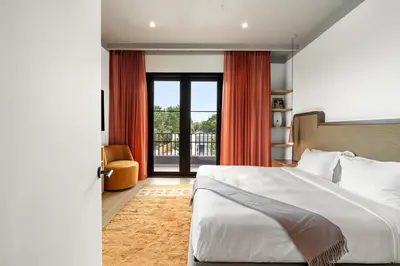 a bedroom with a bed and a large window at The Rover Miami in Miami