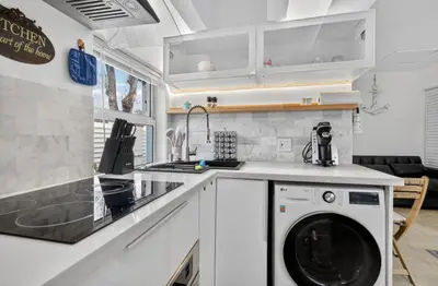 a kitchen with a washer and dryer on a counter at Fort Lauderdale airport and Dania Pointe shopping 5 min away in Fort Lauderdale