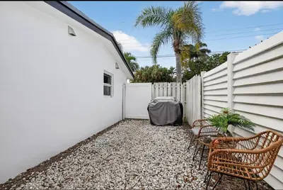 a patio with two chairs and a fence at Fort Lauderdale airport and Dania Pointe shopping 5 min away in Fort Lauderdale