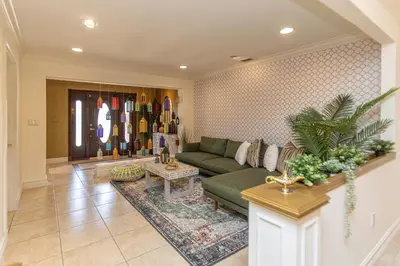 a living room with a green couch and a rug at Miami House - Heated Pool - Family Vacation in Miami