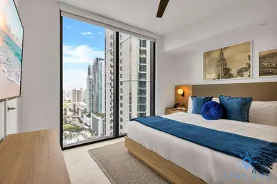 a bedroom with a bed and a large window at Modern 1BR Apartment with Pool in Miami