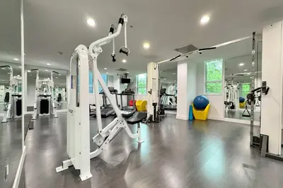 a gym with treadmills and machines in a room at City Loft - Downtown Bayfront pool gym & parking in Miami
