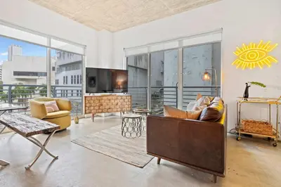 a living room with a couch and a table at City Loft - Downtown Bayfront pool gym & parking in Miami