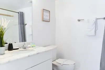 a bathroom with a sink and a toilet and a mirror at Amazing Condo Brickell with Ocean-Pool View in Miami
