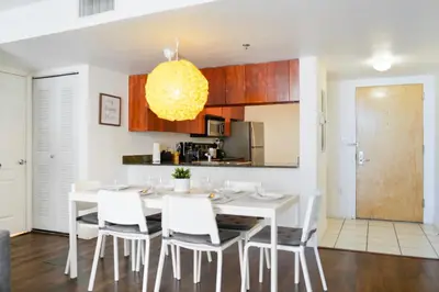 a kitchen and dining room with a white table and chairs at Amazing Condo Brickell with Ocean-Pool View in Miami