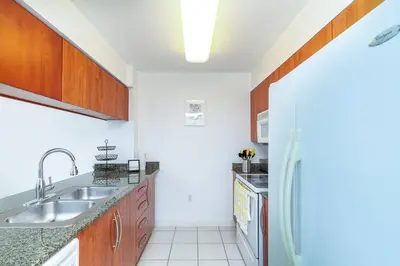 a kitchen with a sink and a refrigerator at Spacious 29th Floor 1 BED 1 BTH Brickell Ocean View in Miami