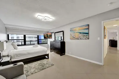 a bedroom with a bed and a large window at Breathtaking 2 Bedroom Condo w Beach Service 919 in Miami Beach