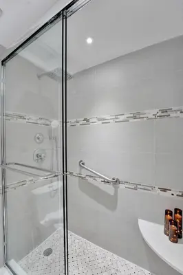 a glass shower in a bathroom with a sink at Breathtaking 2 Bedroom Condo w Beach Service 919 in Miami Beach