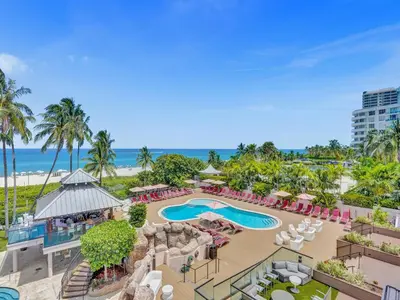an aerial view of a resort with a pool and beach at Luxury Ocean View Condo Resort Amenities 501 in Miami Beach
