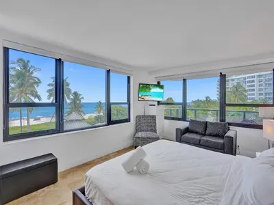 a bedroom with a bed and a view of the ocean at Luxury Ocean View Condo Resort Amenities 501 in Miami Beach