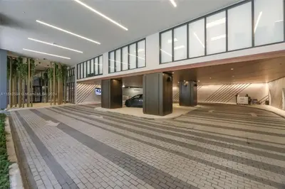 a building with a parking lot with a car in it at La Terrasse by VIAC - Luxury Bay View Studio with Balcony 29th Floor Miami in Miami
