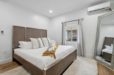a bedroom with a large bed and a large window at Casa Roselle # 1 in Hollywood
