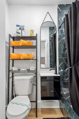 a bathroom with a toilet and a sink and a mirror at Casa Roselle # 1 in Hollywood