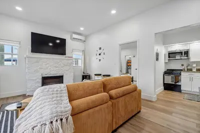 a living room with a brown couch and a fireplace at Casa Roselle # 1 in Hollywood