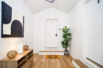 a living room with a wooden dresser and a door at Casa Roselle # 2 in Hollywood