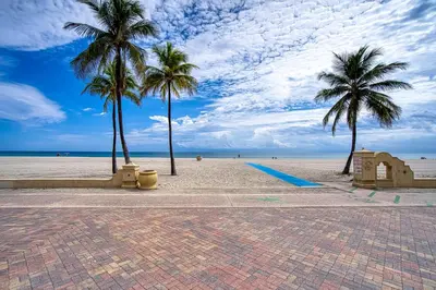 a sandy beach with palm trees and the ocean at Casa Roselle # 2 in Hollywood