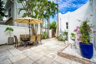 a patio with a table and an umbrella at Casa Roselle # 2 in Hollywood