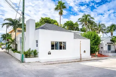 a white house on a street with palm trees at Casa Roselle # 3 in Hollywood