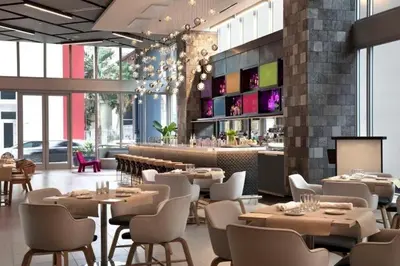 a restaurant with tables and chairs and a bar at Stylish Downtown Miami Getaway 30th Story View in Miami