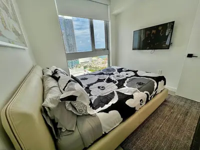 a bedroom with a bed with a cow blanket on it at Stylish Downtown Miami Getaway 30th Story View in Miami