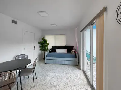 a bedroom with a bed and a table and chairs at Newly Remodeled full Apartment in Miami