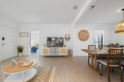 a living room with a table and a dining room at La Casita by TilahStays in Miami