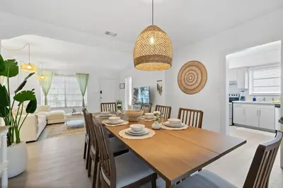 a dining room and living room with a table and chairs at La Casita by TilahStays in Miami