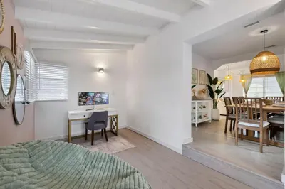 a living room and dining room with a bed and a dining table at La Casita by TilahStays in Miami