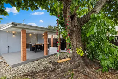 a house with a tree in front of it at La Casita by TilahStays in Miami