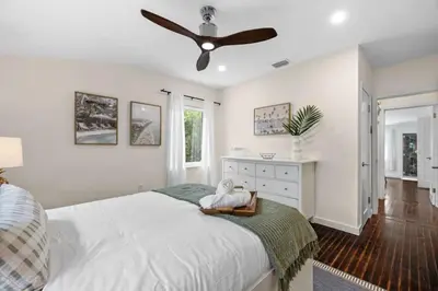 a bedroom with a bed with a ceiling fan at Miami Hidden Garden by TilahStays in Miami