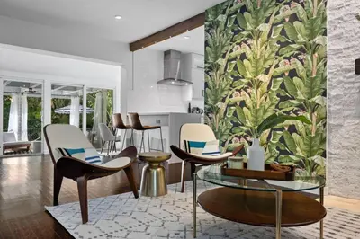 a living room with chairs and a wall mural at Miami Hidden Garden by TilahStays in Miami