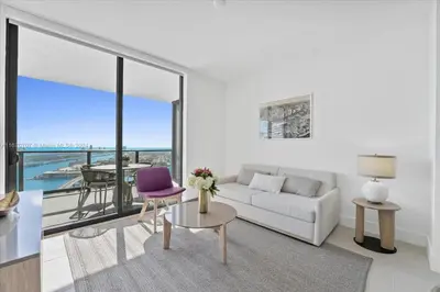 a living room with a white couch and a purple chair at Panoramic Ocean View 3 bedroom Nativo Pool Gym SPA in Miami