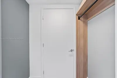 a door leading into a room with white walls at Panoramic Ocean View 3 bedroom Nativo Pool Gym SPA in Miami