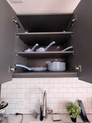 a kitchen with a sink and shelves with pots and pans at Ocean View Entire Condo In Downtown With Pool and Gym in Miami