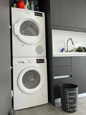 a washer and dryer in a kitchen with a sink at Ocean View Entire Condo In Downtown With Pool and Gym in Miami