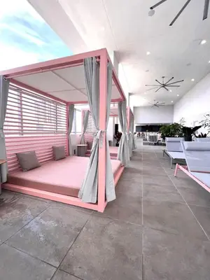 a bedroom with a pink bed in a room at Ocean View Entire Condo In Downtown With Pool and Gym in Miami