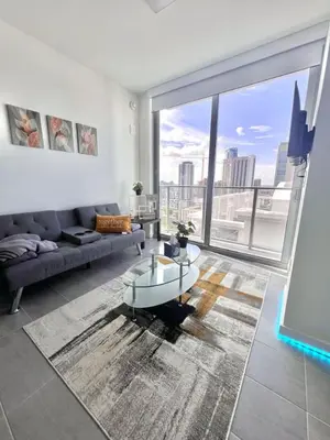 a living room with a couch and a large window at Ocean View Entire Condo In Downtown With Pool and Gym in Miami