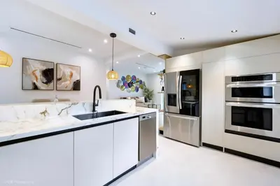 a kitchen with white cabinets and a sink at The Rock & Rhythm Villa Miami Downtown - Playground,Mini Golf, BBQ, Garden Relaxation in Miami