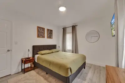 a bedroom with a large bed and a table at Explorer's Retreat Villa in Miami