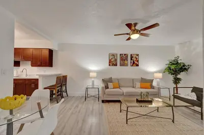 a living room with a couch and a ceiling fan at Explorer's Retreat Villa in Miami
