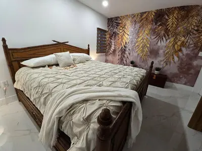 a bedroom with a large bed with a painting on the wall at Sunset Retreat at Heart of Miami with pool in Miami
