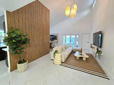 a living room with a white couch and a table at Sunset Retreat at Heart of Miami with pool in Miami
