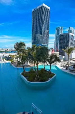 a pool with palm trees in the middle of a city at Magic Miami Penthouse Balcony, Insane Ocean & City Views Luxury,Pool,Spa,Gym in Miami