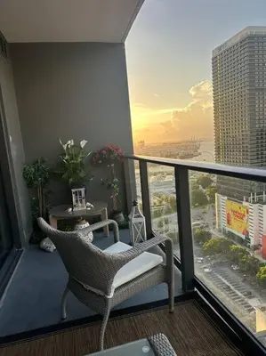a balcony with a chair and a view of a city at Magic Miami Penthouse Balcony, Insane Ocean & City Views Luxury,Pool,Spa,Gym in Miami
