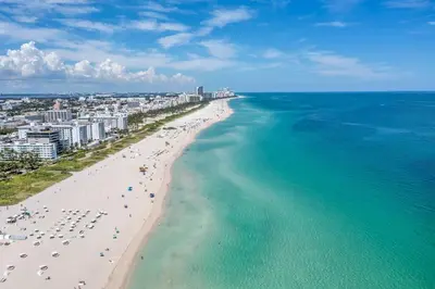 an aerial view of a beach and the ocean at Fantastic Townhouse Beach Access Resort Amenities! in Hallandale Beach