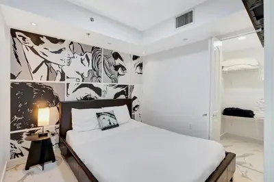a bedroom with a bed and a wall with drawings at Fall in love with Brickell - Your Miami home in Miami